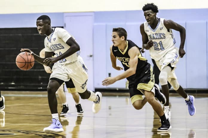 Sharks Sr. Brandon Clarke going for the shot with Mitchell hot on his trail.