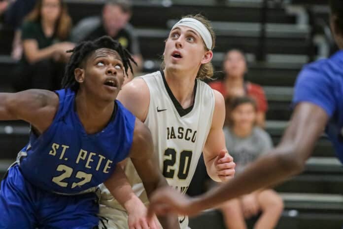  PHSC Daniel Jones competes against SPC Xavier Willes on the free throw lane for a potential rebound recovery.