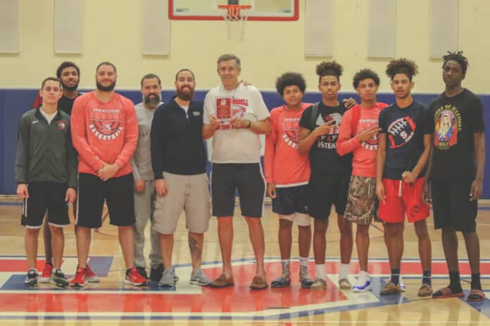  Greg O'Connell (Center) receives a plaque from the Springstead Basketball coaches and players. 