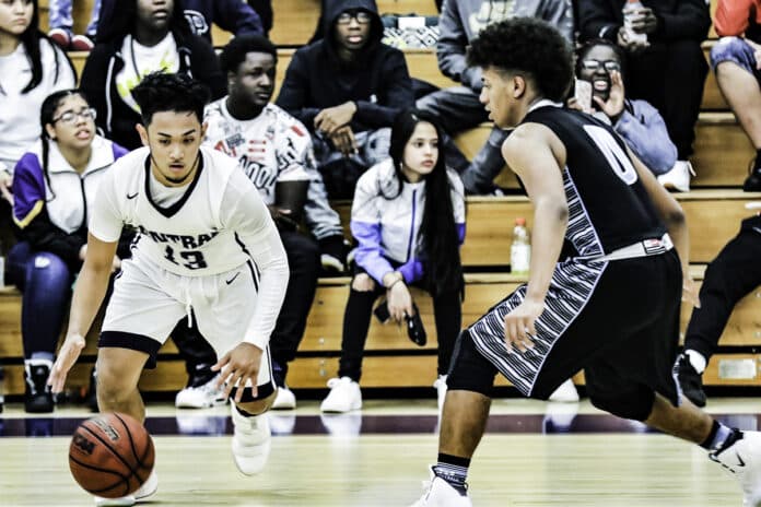 Centrals senior #13 Vince Valencia dribbling around and through Sharks on his way to making a two-pointer for the Bears, Friday night Jan. 25, 2019.