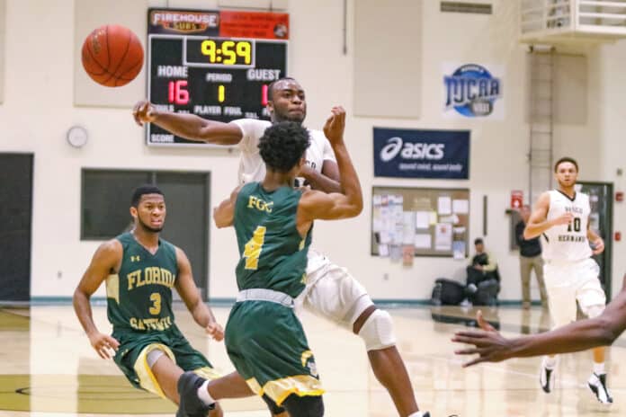 Charles Grandison pushes through Gateways defense during their third game against the college. Grandison recovered 11 rebounds total for PHSC.