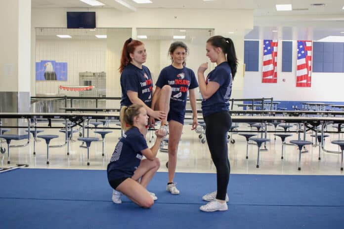 The girls work on techniques during practice in the cafeteria.