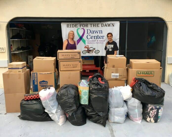 April Johnson, left, the Community Engagement Coordinator at the Dawn Center with Alyssa Barocas, right, and donattions.