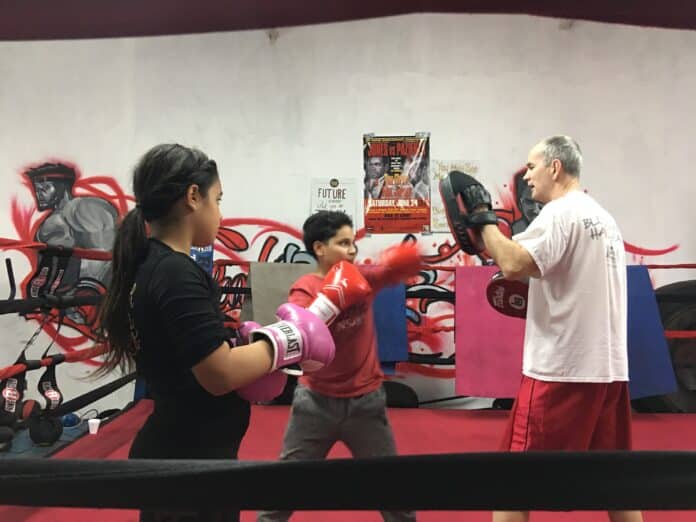 Coach Larry works with a brother and sister