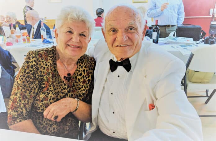 Friedericke Bauer, visiting from Kiefersfelden, Bavaria and Jake Eidenschink, former club president and charter member enjoy the festivities of the Inaugural Ball.