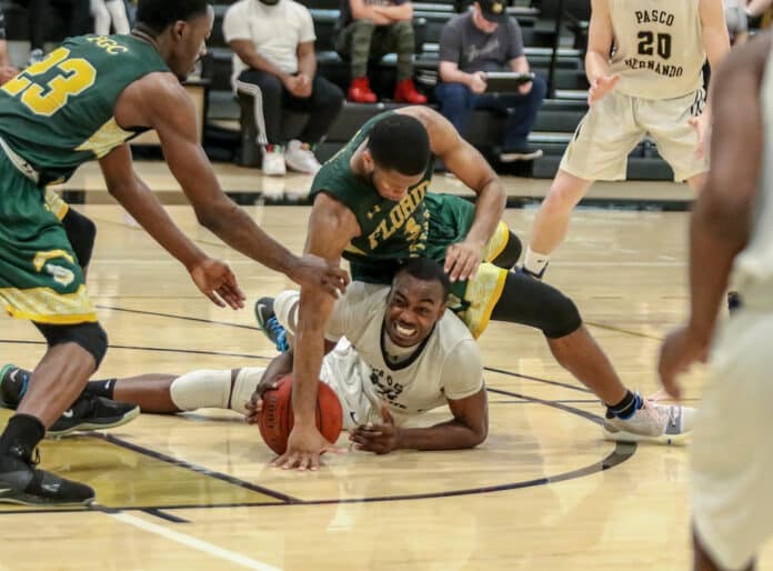  Charles Grandison attempts to recover the ball as Florida Gateway’s Kenny Brown tumbles over him.