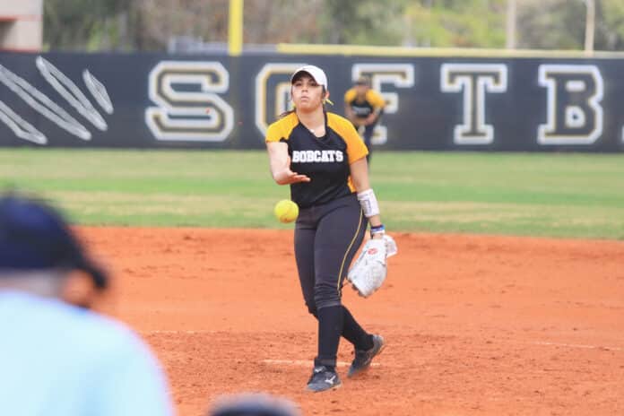 Freshman Andrea Del Toro releases a wind-up as she pitches against Ava Maria