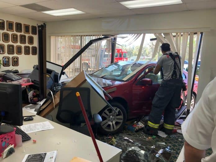 Ford Fusion crashes into office