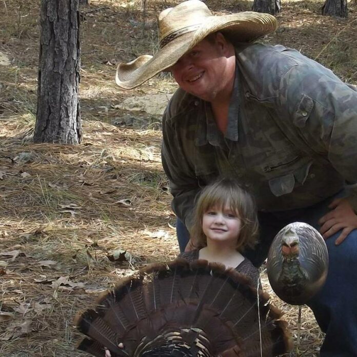 Toby posing with five year old Paige Miller after taking her first gobbler during a youth weekend hunt