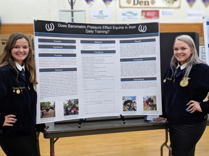 Seniors Victoria Rivera (left) and Summer Blessing (right) with their project, “Does Barometric Pressure Affect Equine in their Daily Training?“  