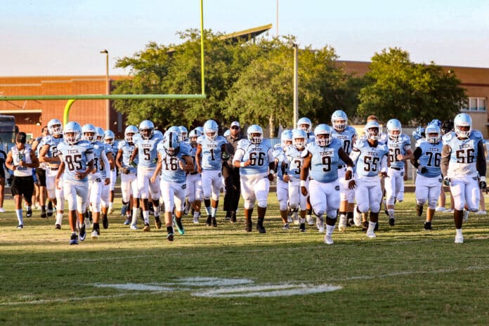 Coach Cory Johns ran onto the field with his team at the Friday night May 24, 2019 scrimmage game against Jenkins High School