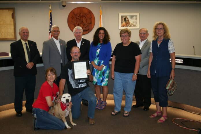 Bob and Kelly Detweiler, along with shelter volunteers and their furry canine friend, Dozer, a rescue dog, accepting the Animal Cruelty Awareness Month proclamation on April 15, 2019 Brooksville City Council meeting.