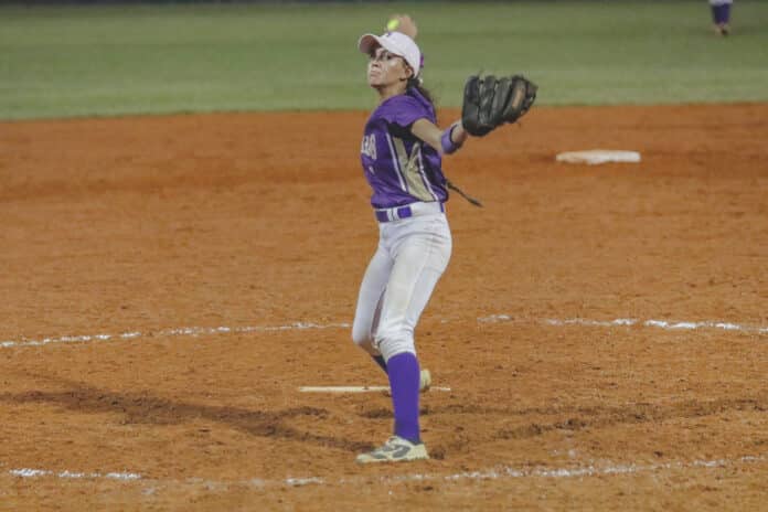 Leopards Senior Ali Shenefield focuses on her fastpitch release during Friday night District Championship game against Cypress Creek at Tom Varn Park. 