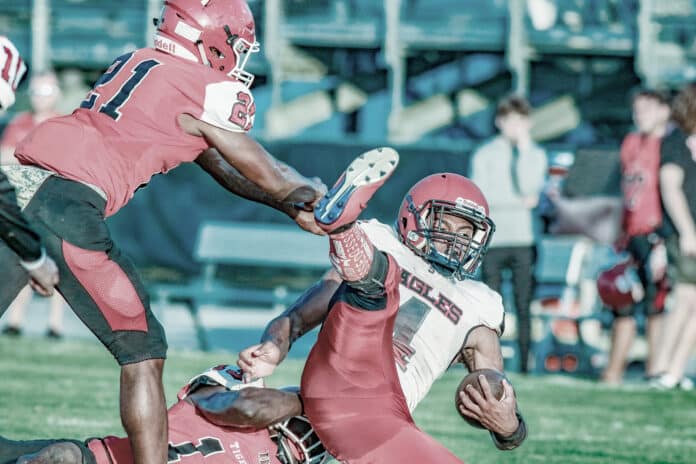 _Springstead @ Dunnellon 2: Tigers Emanuel Caballero (#21) stops Eagles Anthony Alexis from gaining yardage during the Spring football game against Dunnellon Thursday night.