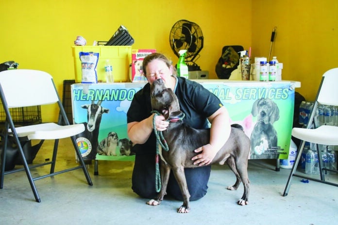 Shannon Finch, the Shelter Coordinator for Hernando County Animal Services, gets some sweet loving kisses from Dudley. Dudley was one of the four dogs not adopted. Hernando Animal Services adopted out 30 dogs and 25 cats during the Tampa Bay Regional Mega Adoption.