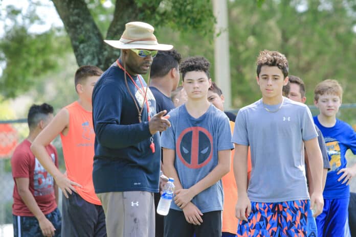 Challenger’s Athletic Director Ryan Wilson discusses the drill with campers. “This is excellent for the kids, and it gives them the foundation of what they are going to do if they decide to play football.” 