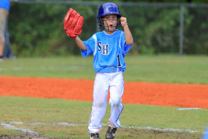 TBall_Wildwood vs Spring Hill 03: Spring Hill Jaiden Edwards show some excitement for the game to begin against Wildwood Saturday during the district tournament being held at Ernie Wever in Brooksville.