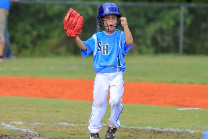 TBall_Wildwood vs Spring Hill 03: Spring Hill Jaiden Edwards show some excitement for the game to begin against Wildwood Saturday during the district tournament being held at Ernie Wever in Brooksville.