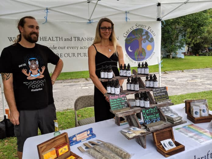 Travis Moorehead and Shannon Hernandez setup at the Brooksville Farmers Market.