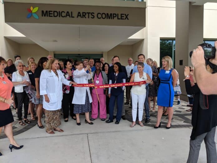 Dr. Bonkowski cuts the ribbon during the medical group's Greater Hernando County Chamber of Commerce Ribbon Cutting ceremony last week. Nurse Practitioner Frances Vitalis is to the left of Dr. Bonkowski.    