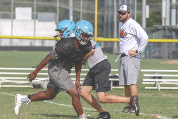 Coach Johns oversees offensive plays during practice at Nature Coast Technical High School.