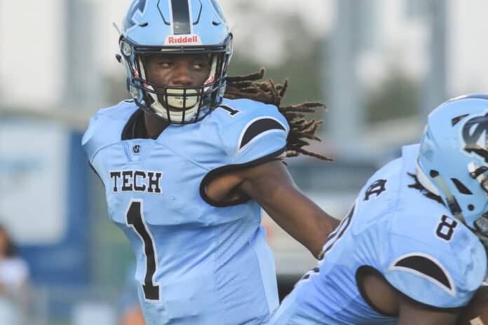 Sharks QB Senior Fabian Burnett hands off to teammate Kinyatah Morgan during the second game of the season. The official season began on August 16 but was rained out.