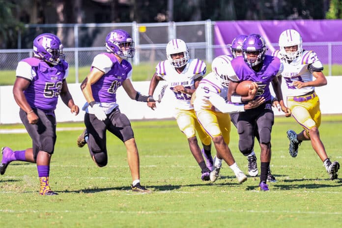 Saturday Sept. 7 2019 at Hernando High, Leapord #5 Jordan Williams breaks through the Hurricanes to go for the touchdown while #11 Jacob Batten and #53 Andre Woods coming in to protect Williams.