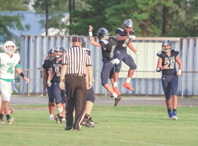 Central’s running back Contae Cason, and Quarterback Tre Joyner celebrate a touchdown in the endzone.