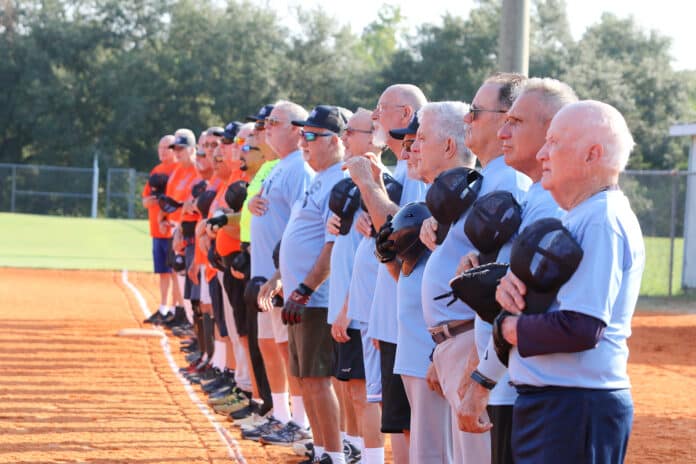 Players aligned on the field as the National Anthem was performed by the American Legion Post 186 Color Guard.