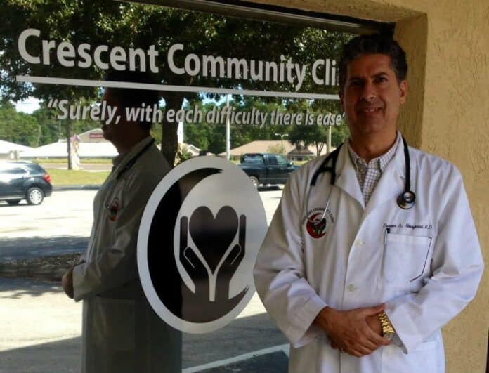  photo of DR. AbuZarad for first photo with cutline: Dr. Husam AbuZarad in front of the clinic in Spring Hill, Florida. Photo courtesy of Crescent Community Clinic.