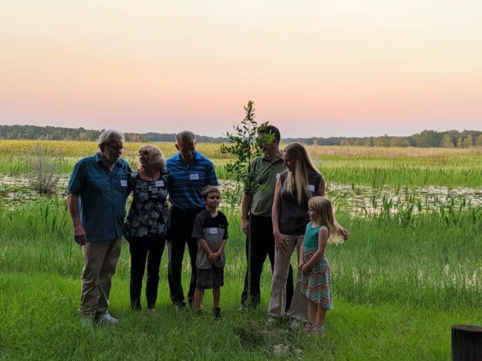 Dra. Schramm's family plants a tree in her memory at Crews Lake Park, where she enjoyed many miles of riding the bike trails.