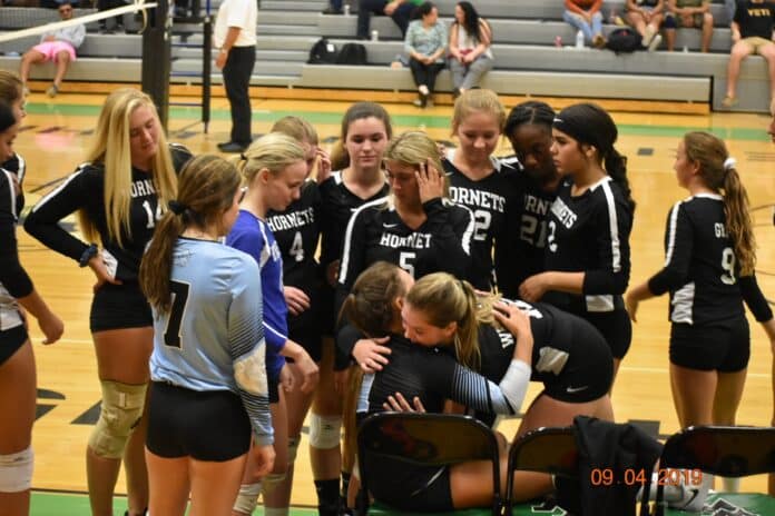 Hornets console NCT setter Karla Cantero-Garcia after she sustained an ankle injury during the match. Photo courtesy of Eileen Colleran.