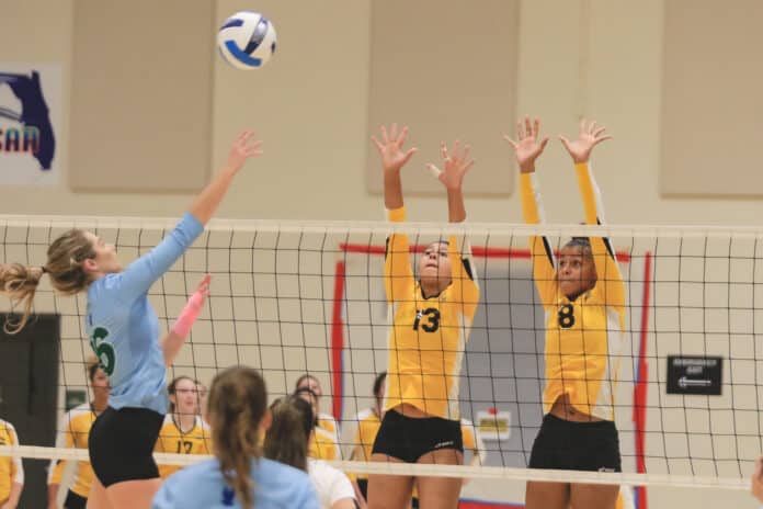 PHSC Arianna Colon (13) and Olivia Jones (8) attempt to block a spike from Lake Sumter State Talyn Allard (16)