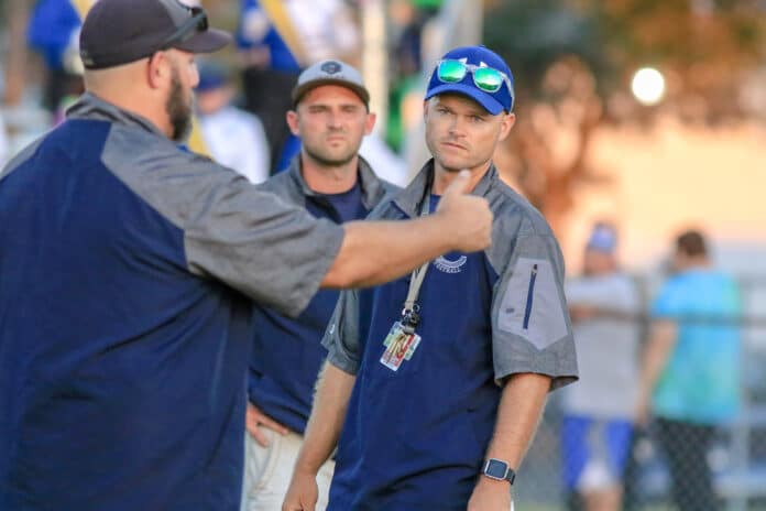 Central head football coach Robert Walden goes over plays before the game against Crystal River on Friday night, Oct 11 at Central High School in Brooksville