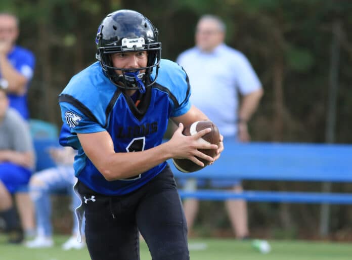 HCA’s Quarterback Evan Klukowski rushes through Hillsborough Baptist defense line. Klukowski rushed 154 yards and three solo tackles against Hillsborough Baptist.