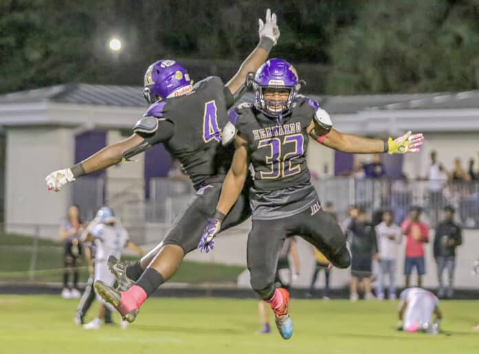 Leopards' Koby Winn (32) and Isaiah Brown (4) celebrates an interception on Shark’s goal line