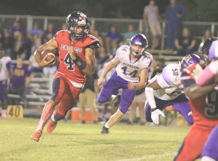 Eagles Senior Anthony Alexis rushes to gain yardage for a first down against Hernando Friday night at F. W. Springstead High School.