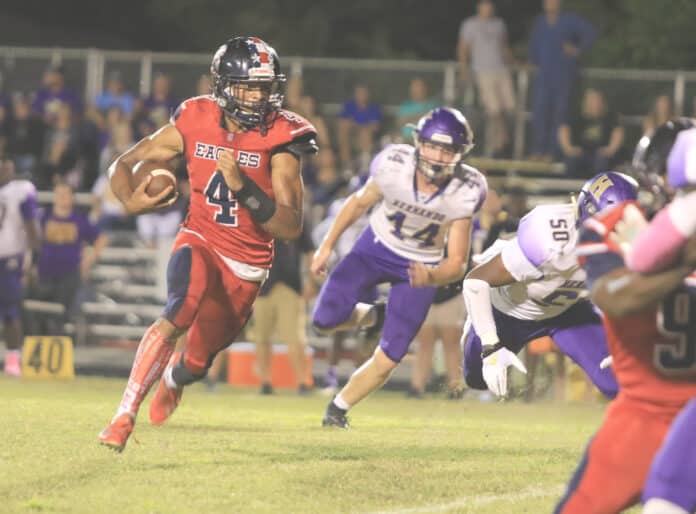 Eagles Senior Anthony Alexis rushes to gain yardage for a first down against Hernando Friday night at F. W. Springstead High School.