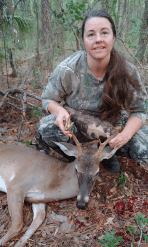 Mrs Kelli Sims Ellis with a handsome five point buck who couldn't resist a whiff of estrous scent