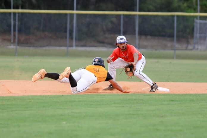 HSC Freshman Nicolas Cinelli from Inspiration Academy slides back to first base before SWFL Trey Bacon attempts to tag