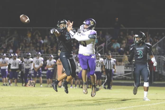 Hornets’ Joseph Chavis Kenny Davis slaps the football away from Leopards’ Matthew Gillespie in his attempt to catch the pass.