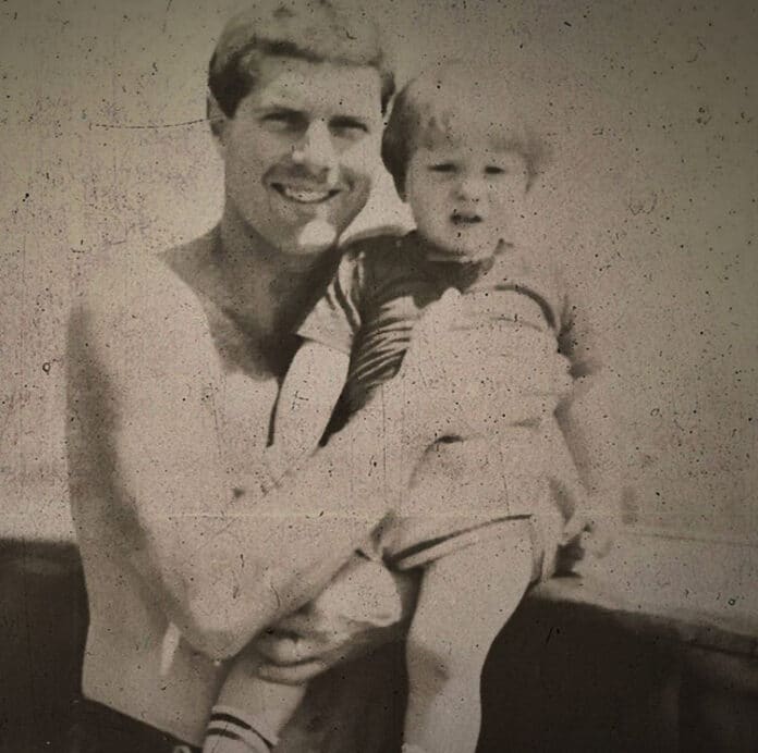 Sean Dietrich as a young child held by his father