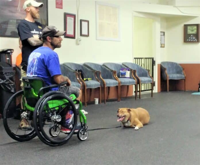 Ron Flaville (standing) with Dan and his K-9 partner Gloria.