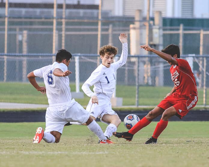 Central’s Lincoln Rice (1) and Will Torres (6) creates a driving force in attempted to gain control of the ball against Hudson’s  Tyler Hernandez