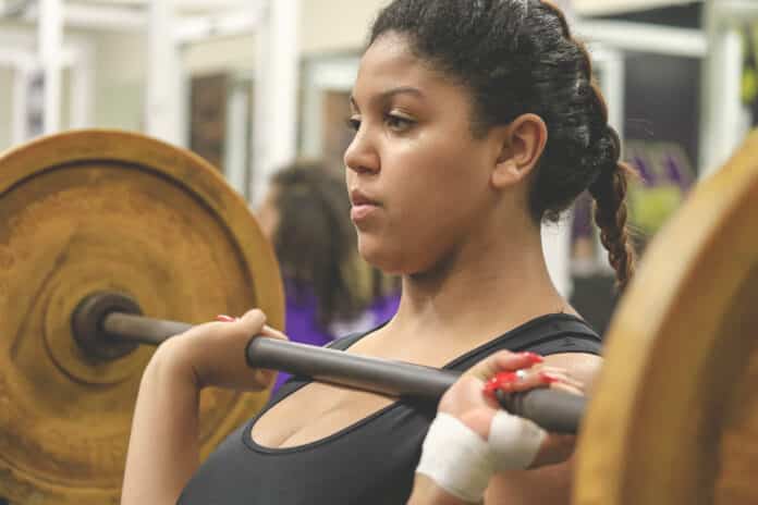 Jania Edwards from Weeki Wachee executes a clean and jerk during the tri-meet at Hernando High School on Wednesday afternoon. 