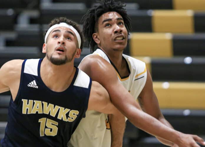 Hawk’s Eduardo Peralta-Garica (15) tries to keep PHSC Warren McLymont from advancing to a free throw rebound during the game on Tuesday night Nov. 13, 2019 at PHSC in New Port Richey.