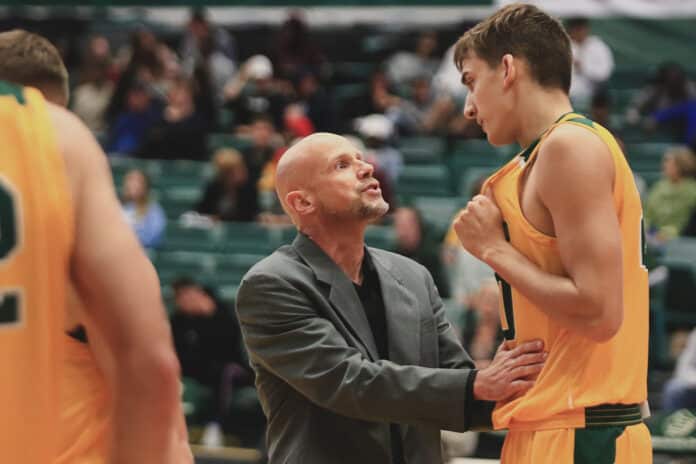  St. Leo’s basketball coach Lance Randall talks with Eric Lahm during the home opener Sunshine Conference at St. Leo University on November 16. 