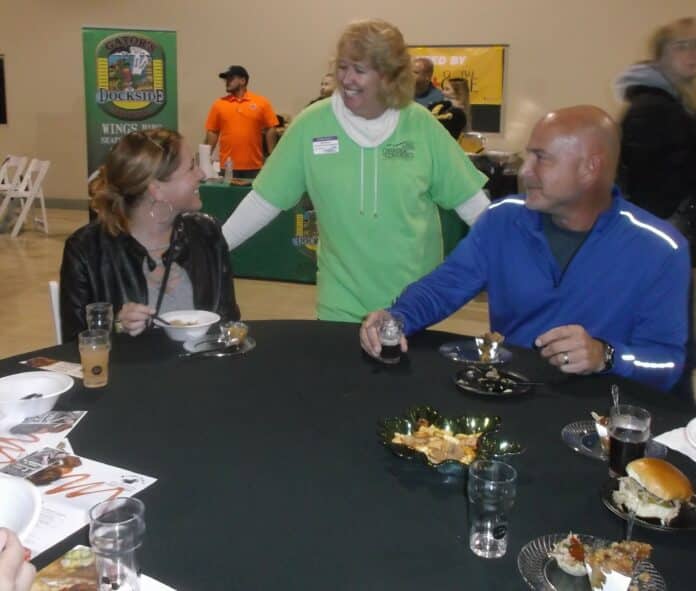 Volunteer Deb Weaver visits with some members of the crowd