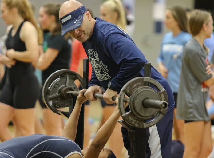 Central Coach Joe Nestor spots his lifter during the All-County meet held at Weeki Wachee High School on Wednesday, December 18.