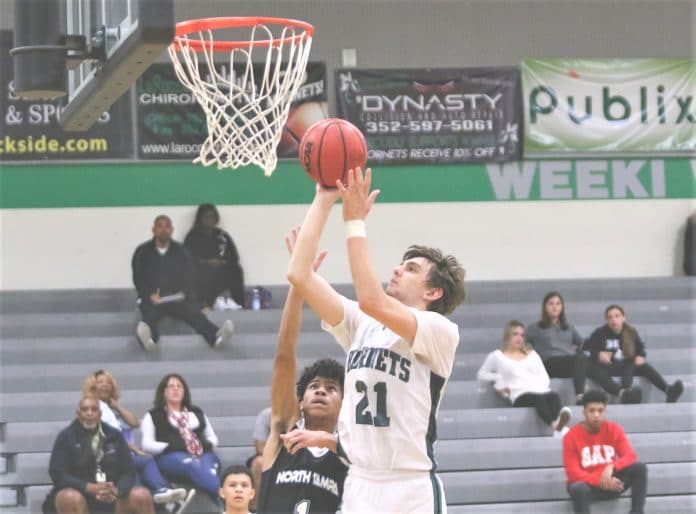 Hornets Dame Zitzelberger (21) goes up for two points as North Tampa Christian Academy’s Kai DeLeon attempts to block.